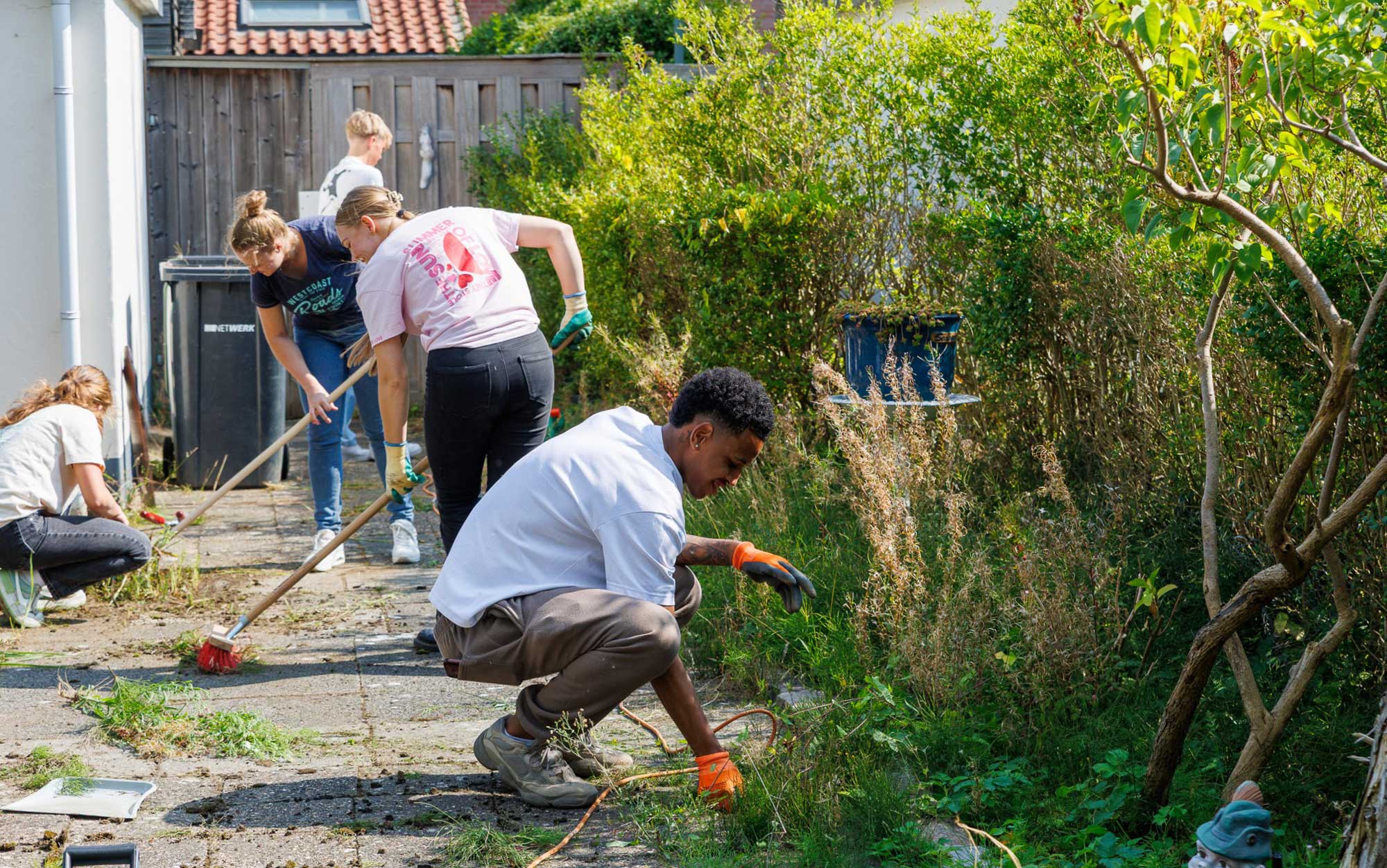 Vrijwilligers van Dordtse Helden in de tuin aan het werk